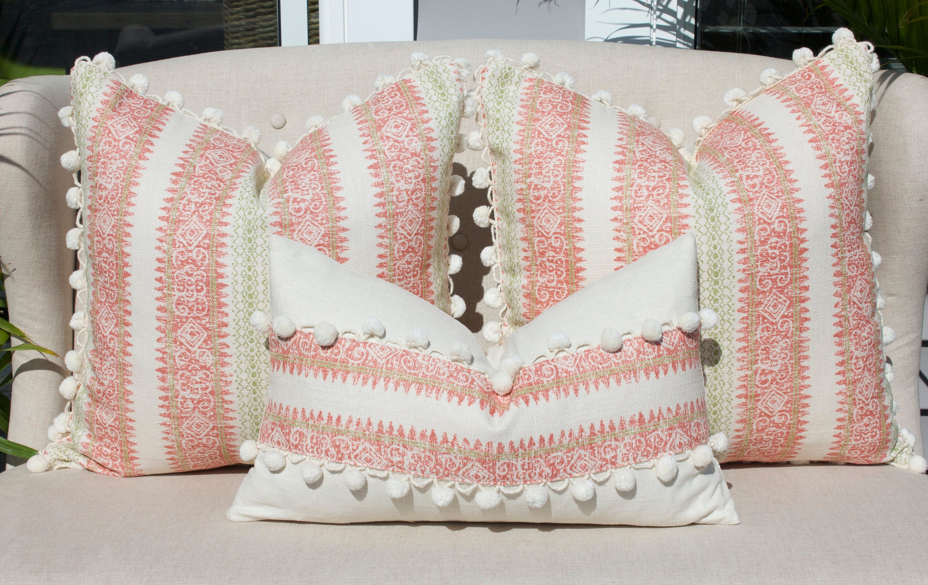 Boho Striped Pillow Cover in Coral and Lime Green embellished with Cream Ball Fringe.
